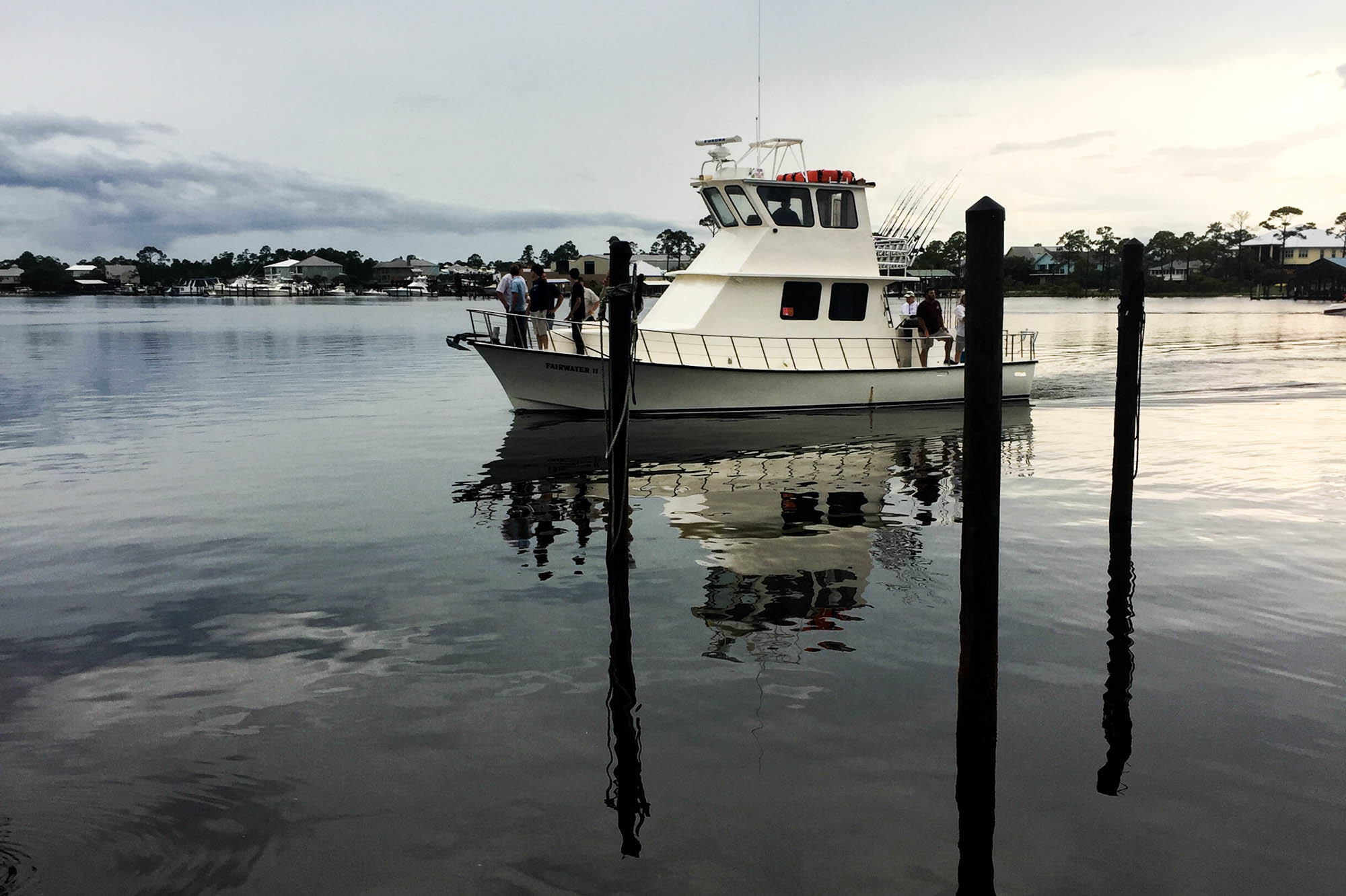 The charter boat Fairwater Two pulls into its slip at Zeke's Marina. &quot;Everybody can get off the boat except the guy with the money,&quot; jokes Captain Tom Ard after he docks the boat. He's back from a day-trip chartered by a Tennessee businessman taking his clients on a fishing trip. They've caught nearly two dozen nice sized red snappers. (Debbie Elliott/NPR)
