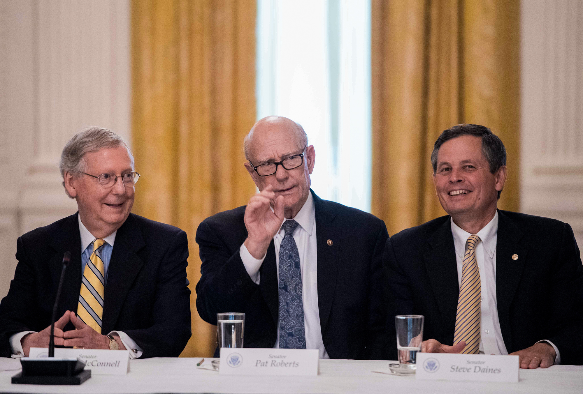 Steve Daines of Montana (right) talks with fellow Republican Sens. Mitch McConnell and Pat Roberts in a White House meeting in June on the GOP health care strategy, which would include deep cuts to Medicaid. Montana insurers say the plan worries them. (Nicholas Kamm/AFP/Getty Images)