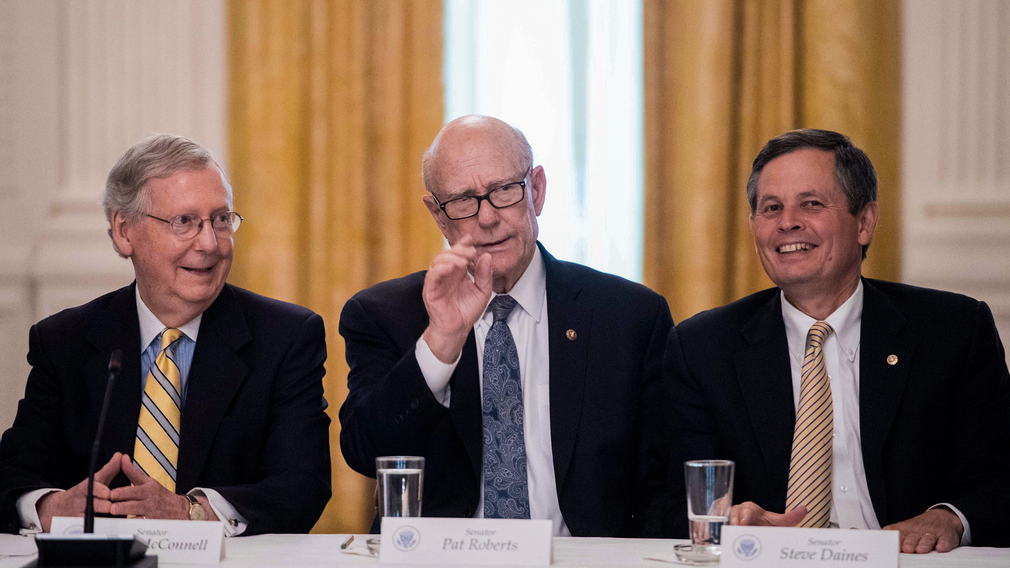 Steve Daines of Montana (right) talks with fellow Republican Sens. Mitch McConnell and Pat Roberts in a White House meeting in June on the GOP health care strategy, which would include deep cuts to Medicaid. Montana insurers say the plan worries them.