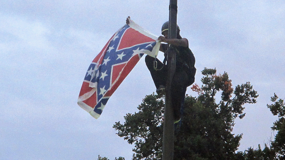 Activist Bree Newsome scaled a flagpole and removed the Confederate flag from a monument at the Statehouse in Columbia, S.C., following a deadly shooting at a historically black church in Charleston. The flag was officially removed from the grounds days later on July 10. (Bruce Smith/AP)