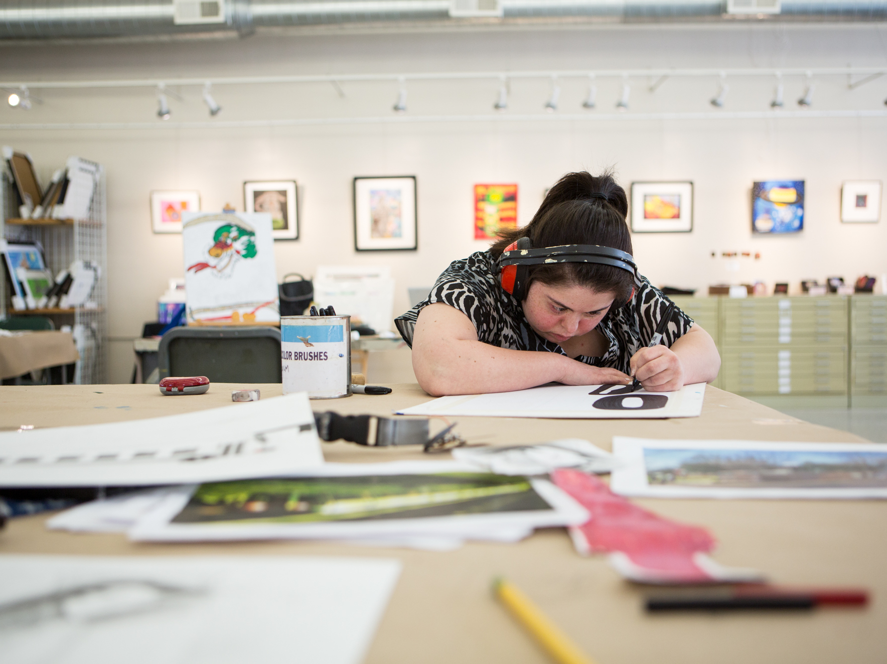 Jamila Rahimi works at Art Enables on a Monday afternoon. Rahimi, who has been working at the studio since 2006, creates the structure of her drawings with permanent marker before adding color. (Becky Harlan/NPR)