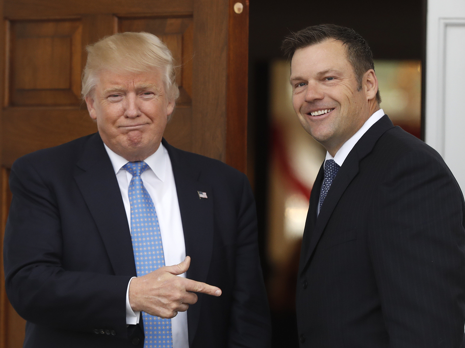 Kansas Secretary of State Kris Kobach, who was eventually named vice chair of a commission on election integrity that has been beset with controversy, joins then-President-elect Donald Trump at the Trump National Golf Club in Bedminster, N.J., in November 2016. (Carolyn Kaster/AP)