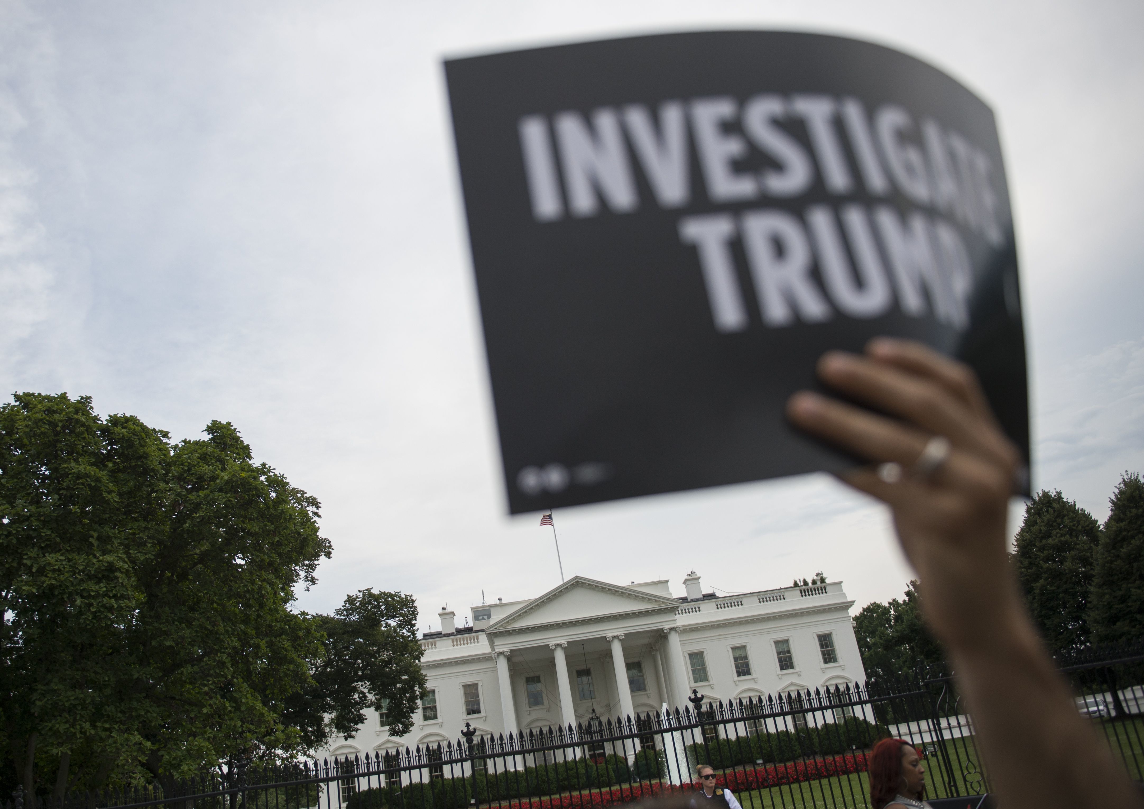 A protester holds up a sign during a July 11 rally calling for accountability regarding alleged collusion between the Trump campaign and the Russian government. (AFP/Getty Images)