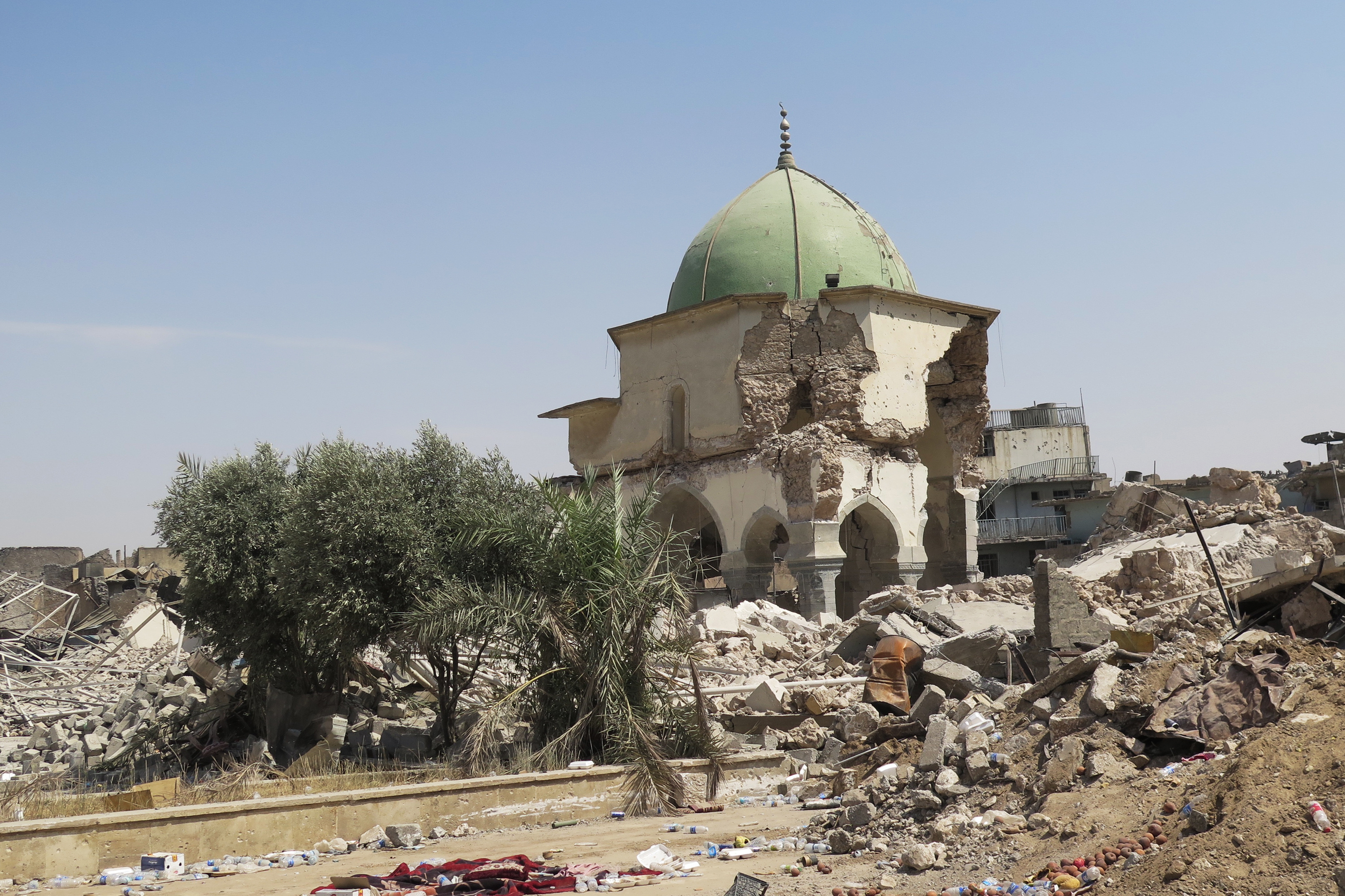 Ruins are all that remain of the 12th century Great Mosque of al-Nuri, where ISIS leader Abu Bakr al-Baghdadi declared three years ago that an Islamic state was rising again. ISIS blew the mosque up as Iraqi forces advanced. (NPR)