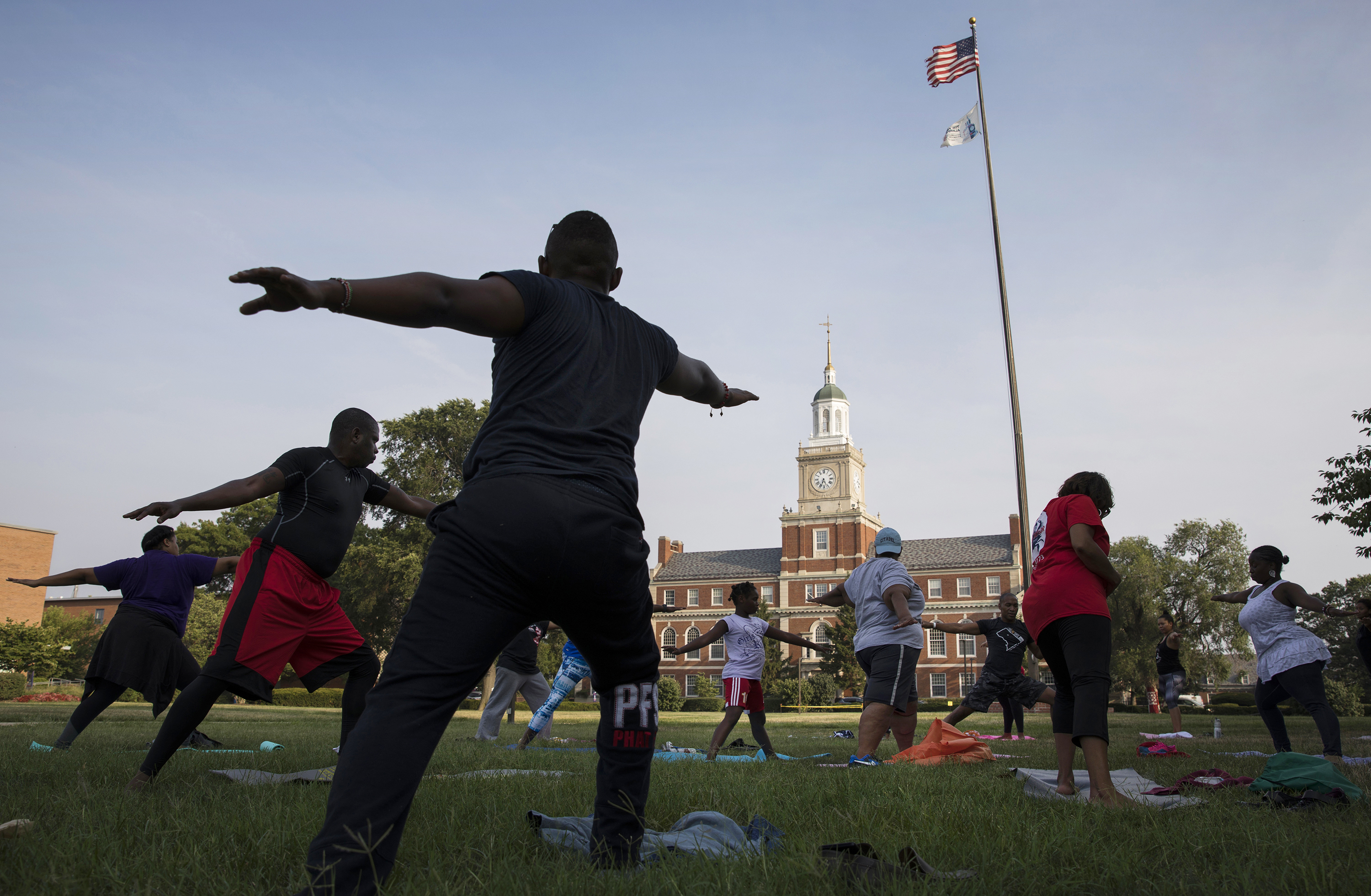 Participants stretch during a &quot;yoga on the yard&quot; class, one of Howard University's sesquicentennial celebration events that was open to anyone in Washington, D.C., who wanted to attend. The university is trying to foster better relations with the surrounding community. (WAMU)