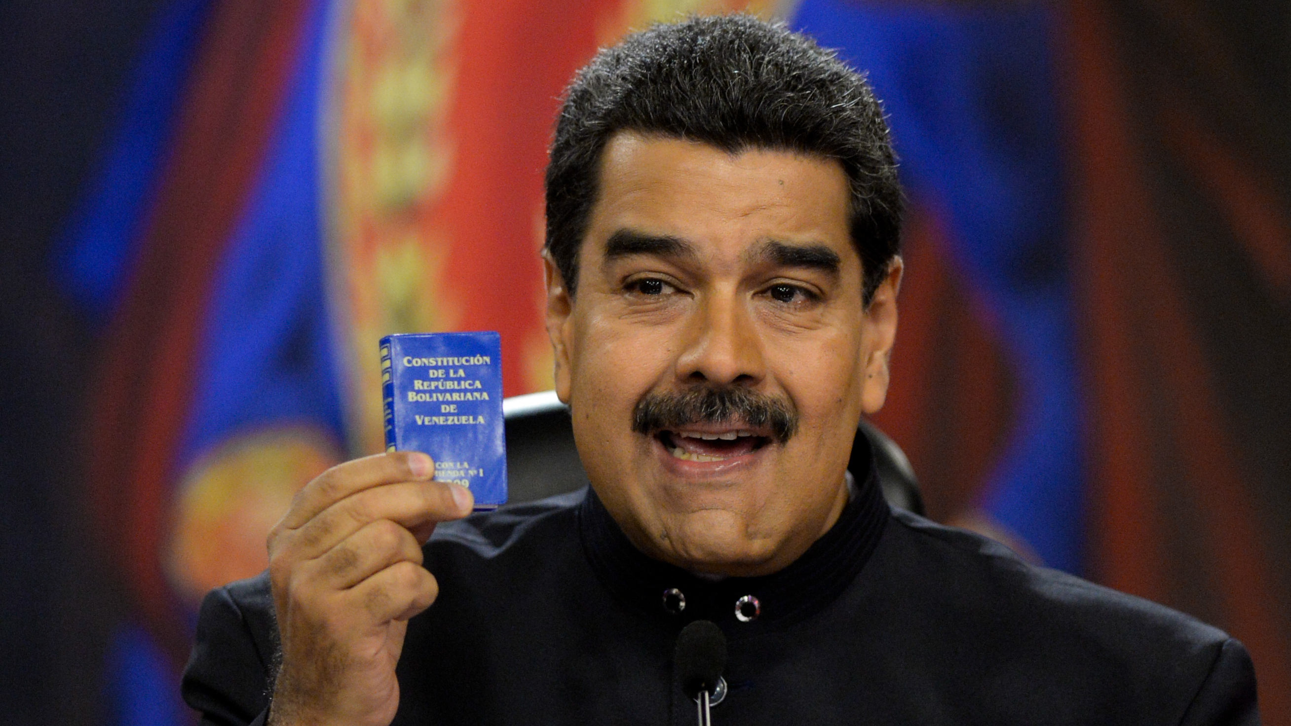 Venezuelan President Nicolas Maduro, holding up a small copy of the country's constitution, during a press conference on June 22, 2017. (AFP/Getty Images)
