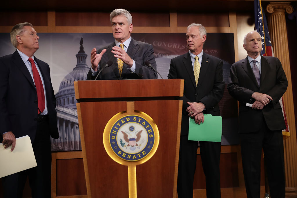Sen. Lindsey Graham (from left), Sen. Bill Cassidy, Sen. Ron Johnson and Sen. John McCain, all Republicans, announced Thursday that they would not vote for a so-called skinny repeal of the Affordable Care Act without assurances from the House that the bill would go to conference. (Getty Images)