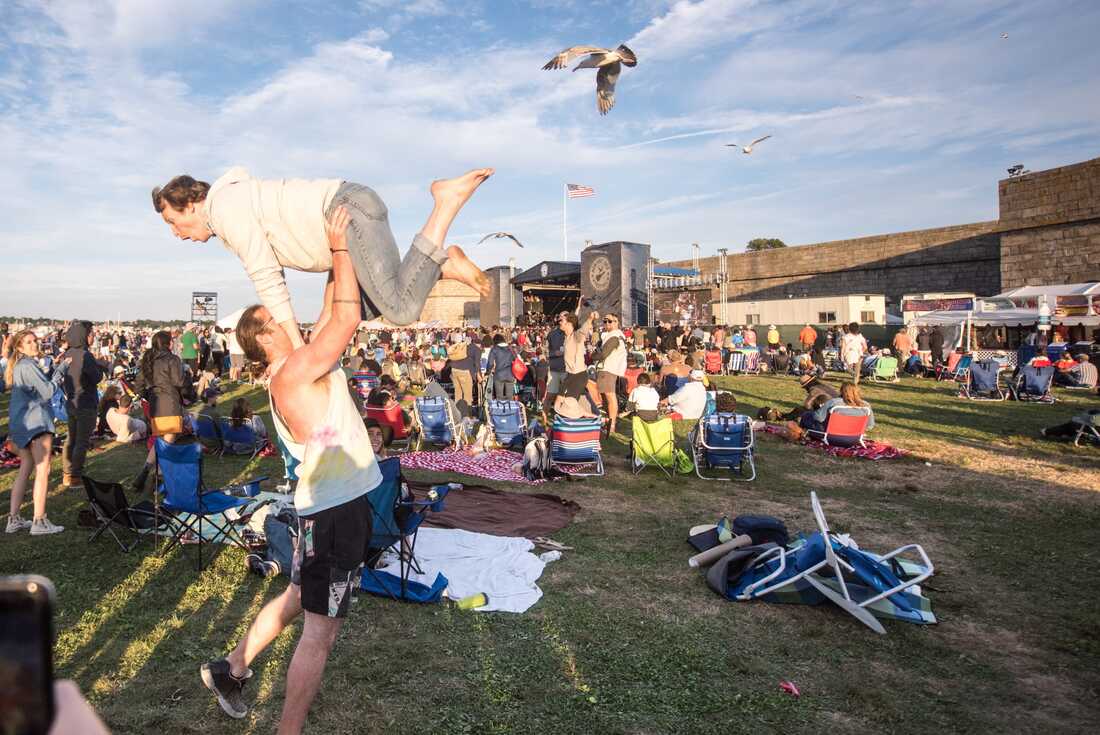 Two audience members dance during Wilco's set at the 2017 Newport Folk Festival.