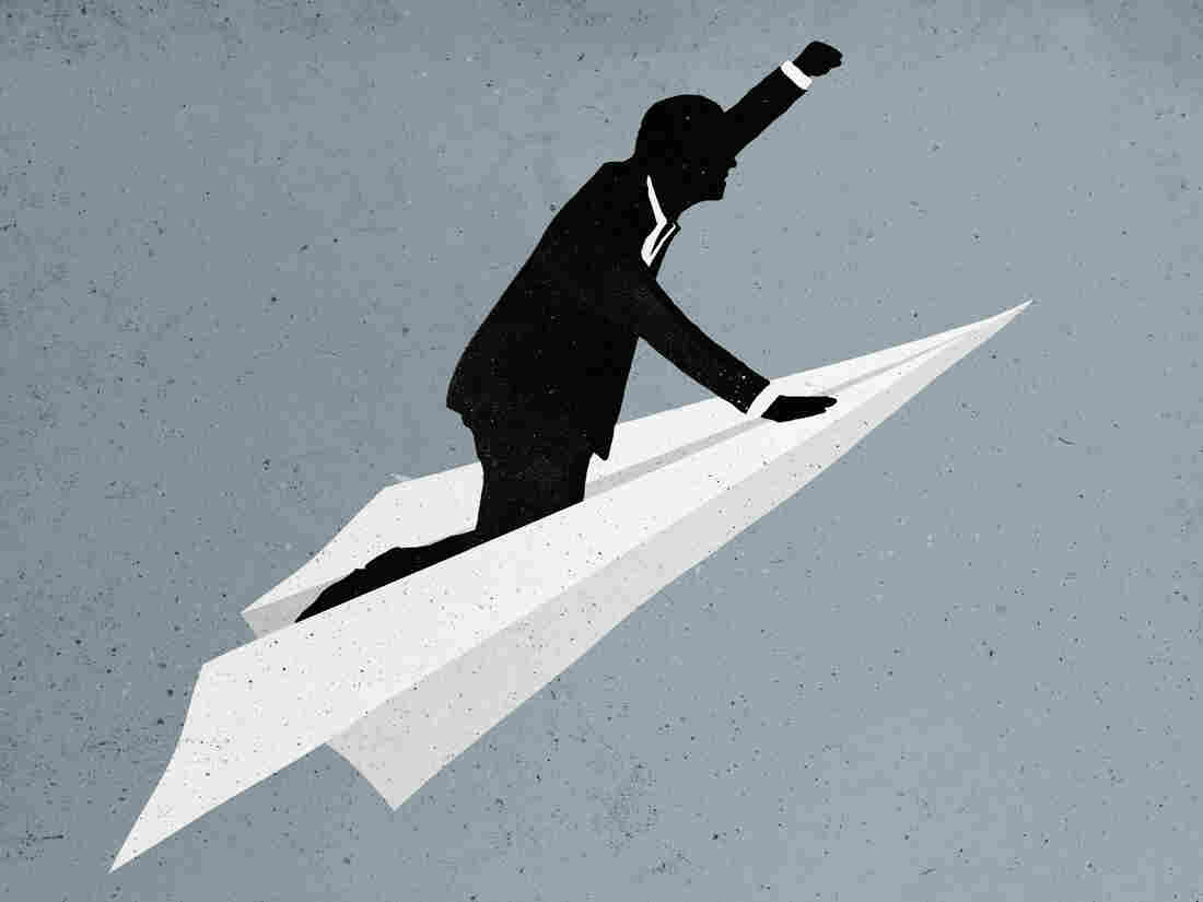 man flying on a paper airplane