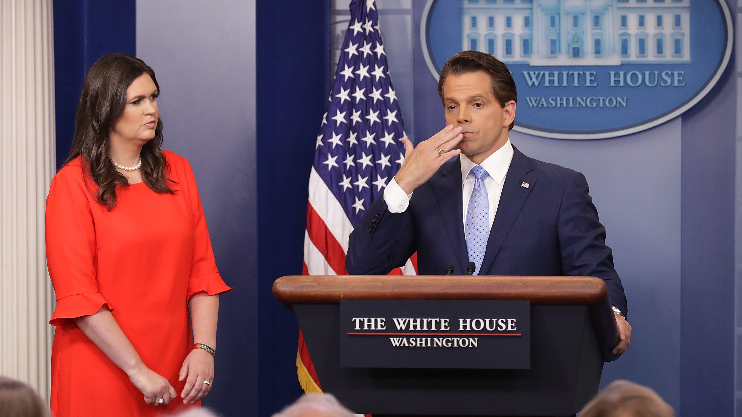 Anthony Scaramucci blows a kiss to the gathered press in the White House briefing room on July 21, as White House press secretary Sarah Huckabee Sanders stands by. (Getty Images)