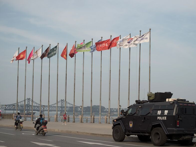 An armored Chinese police van is seen next to the Friendship Bridge on the Yalu River connecting the North Korean town of Sinuiju and the Chinese city of Dandong. China is North Korea's biggest trading partner. (Nicolas Asfouri/AFP/Getty Images)