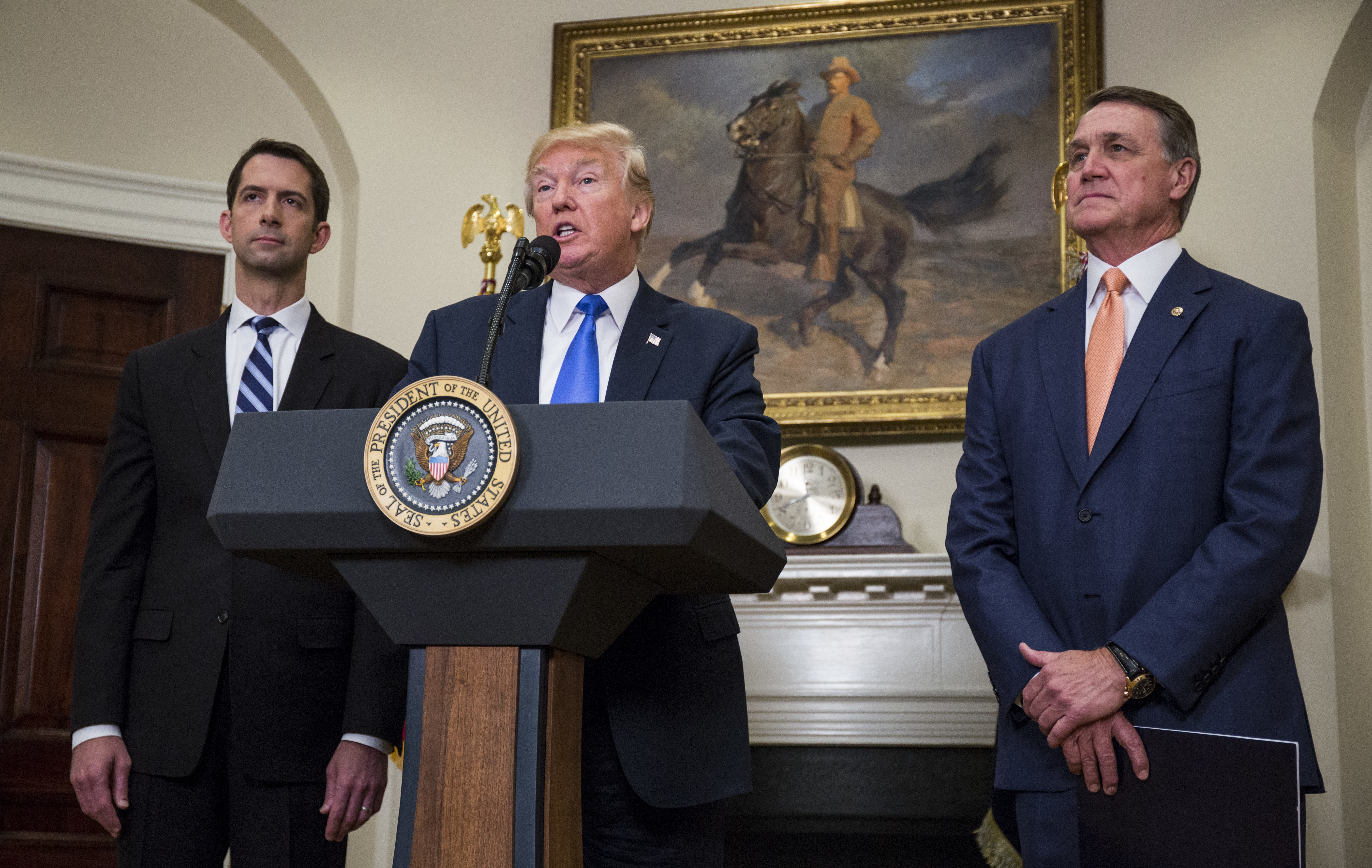 President Trump announces the introduction of the Reforming American Immigration for a Strong Economy (RAISE) Act with Sen. Tom Cotton, R-Ark. (left), and Sen. David Perdue, R-Ga., in the Roosevelt Room at the White House on Wednesday. (Getty Images)
