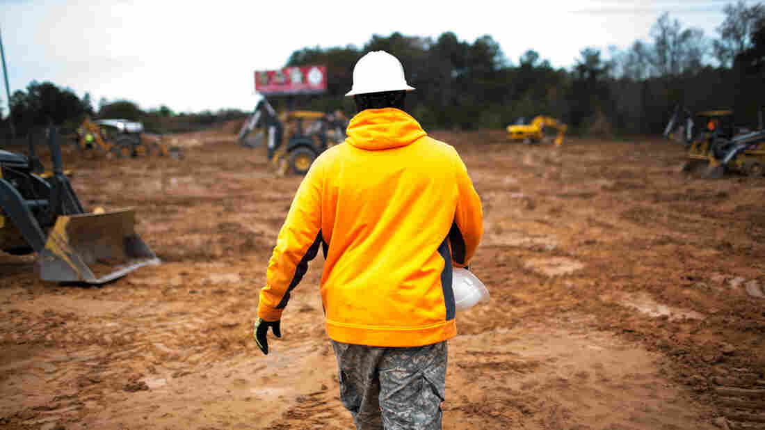 A man walks through a construction site during a training on heavy construction equipment in Conyers, Ga.