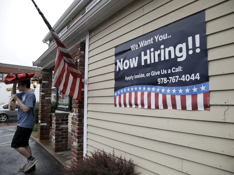 A sign advertising job openings hangs outside a restaurant in Middleton, Mass., last month. At 4.3 percent unemployment, the jobs rate is near the point that most economists deem full employment. (Elise Amendola/AP)