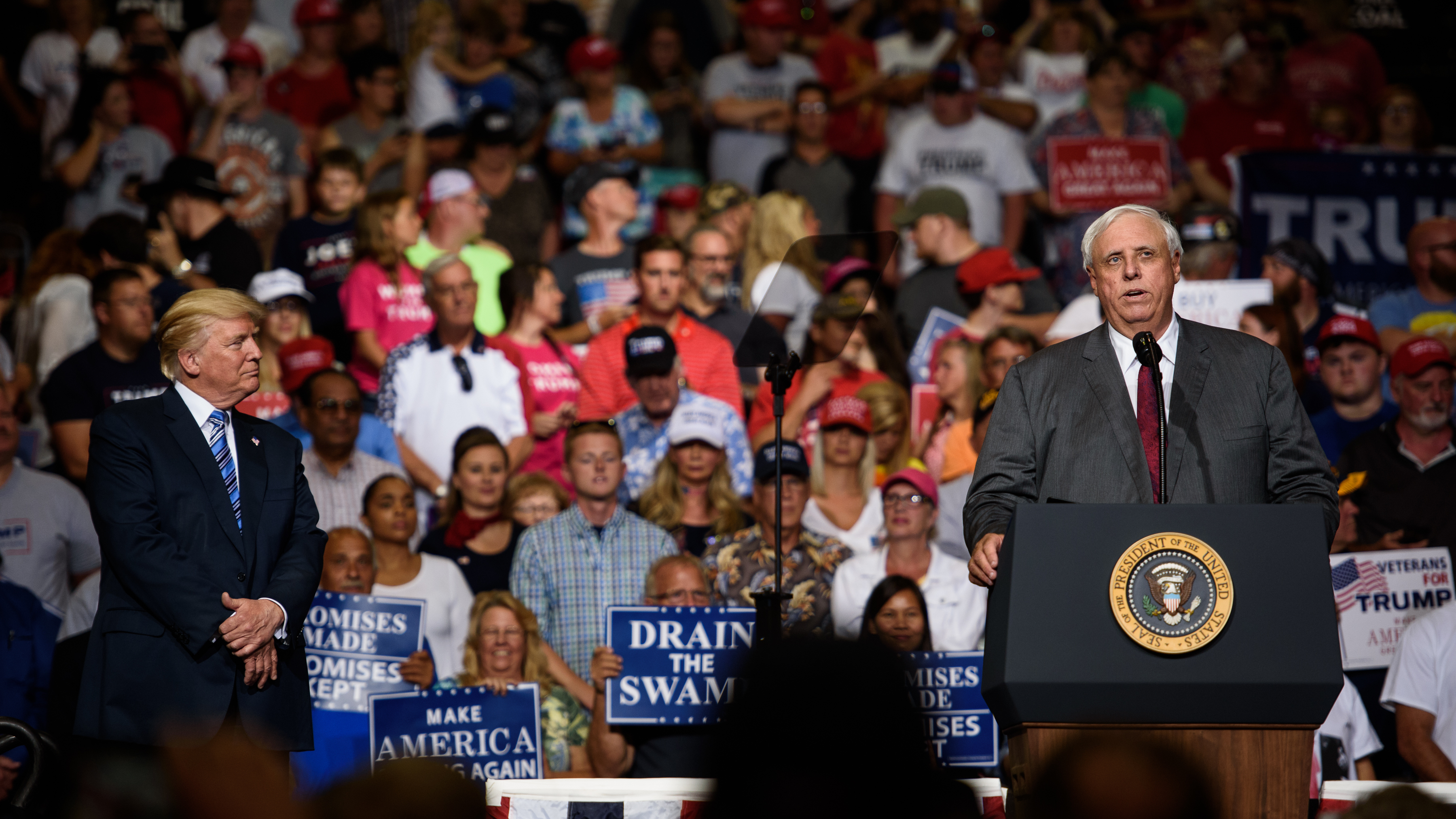 West Virginia Gov. Jim Justice announces that he is switching parties to become a Republican as President Trump listens on at a campaign rally Thursday in Huntington, W.Va. (Getty Images)
