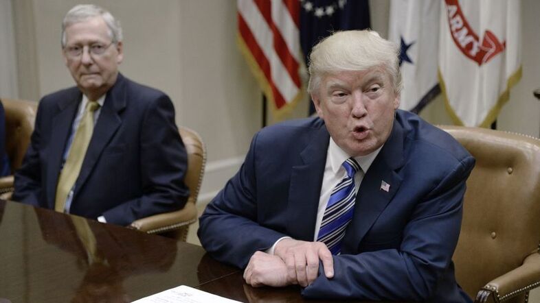 President Trump speaks as Senate Majority Leader Mitch McConnell, R-Ky., looks on during a meeting with House and Senate leadership at the White House in June. (Pool/Getty Images)