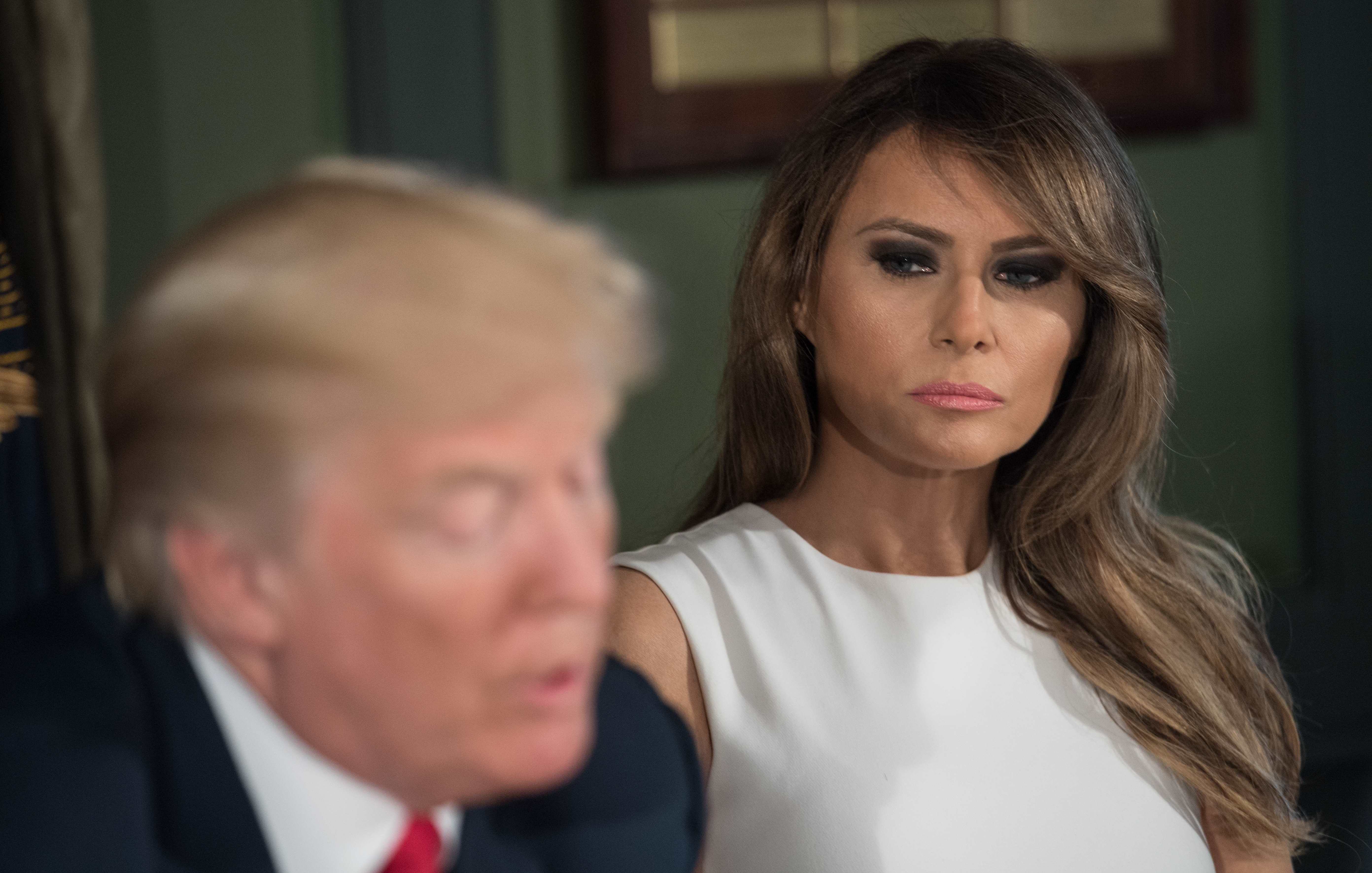 First lady Melania Trump listens to her husband, President Trump, speak at a meeting with administration officials on the opioid addiction crisis at the Trump National Golf Club in Bedminster, N.J., on Tuesday. (AFP/Getty Images)