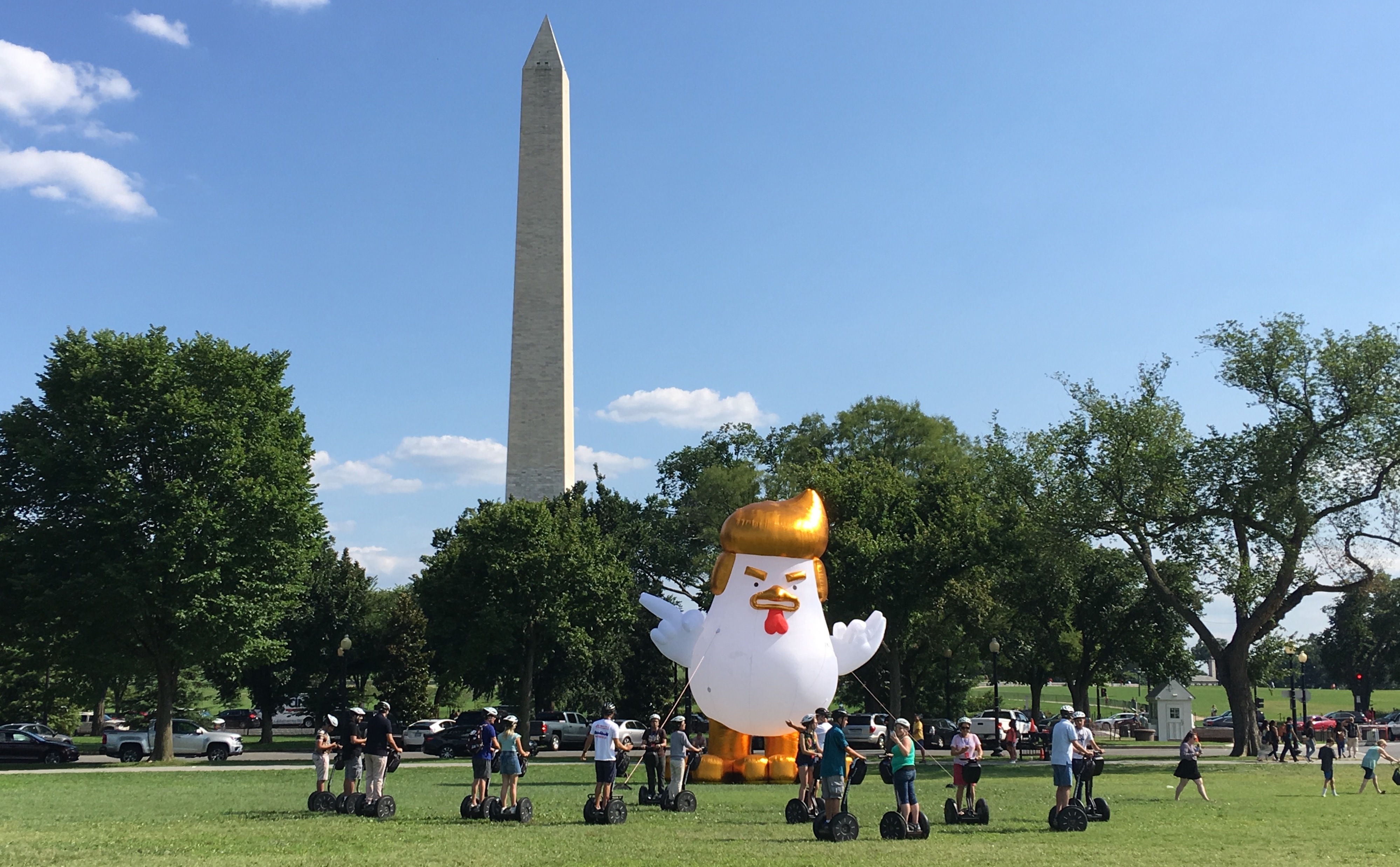 Giant inflatable chicken with golden hair perched right outside of White House Giant inflatable chicken with golden hair perched right outside of White House