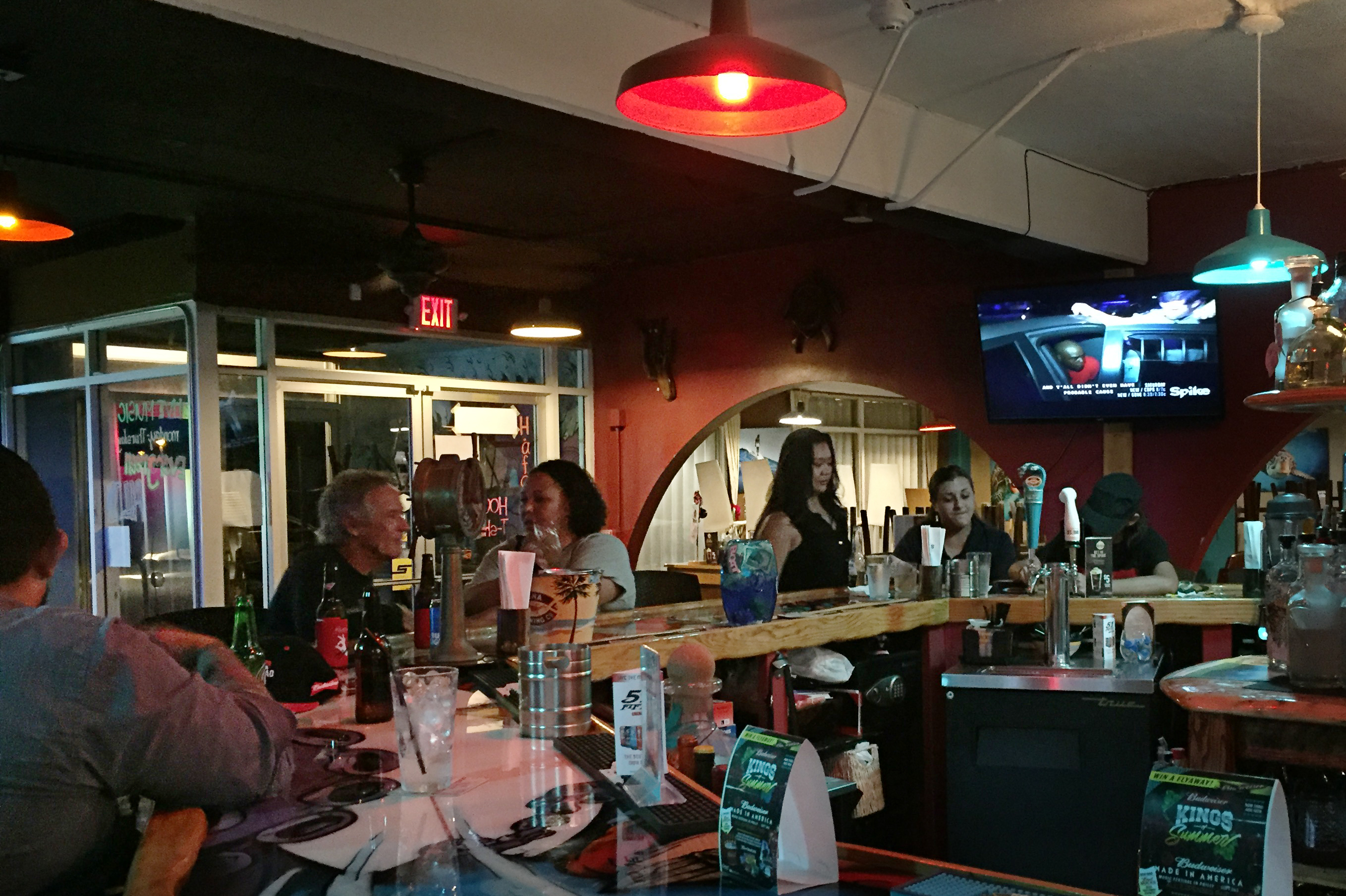 At Mosa's Joint in Guam, island residents and military personnel fill up the bar for Thursday happy hour. (NPR)