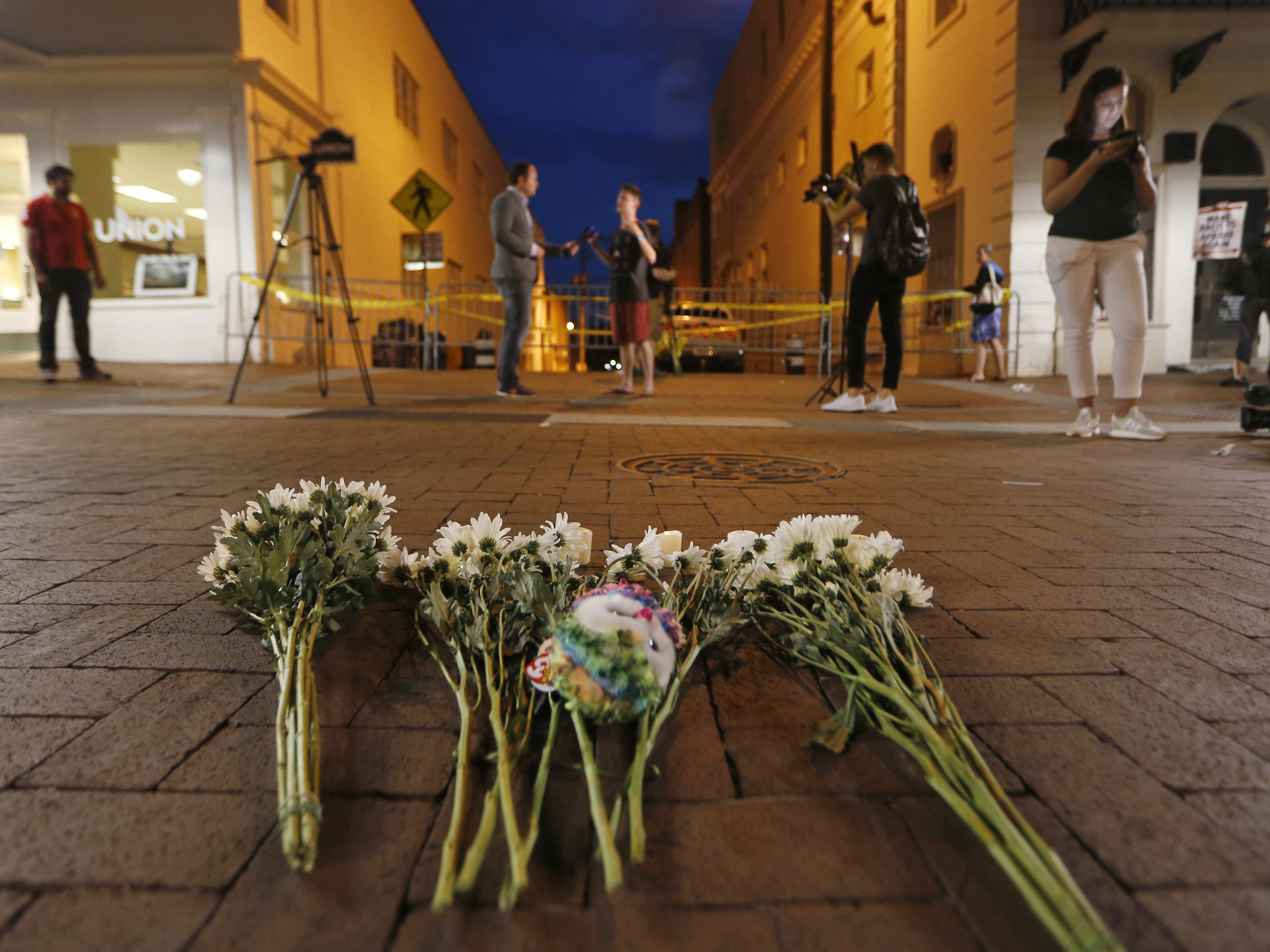 Flowers and other mementos are left at a makeshift memorial for the victims of Saturday's violence in Charlottesville, Va.