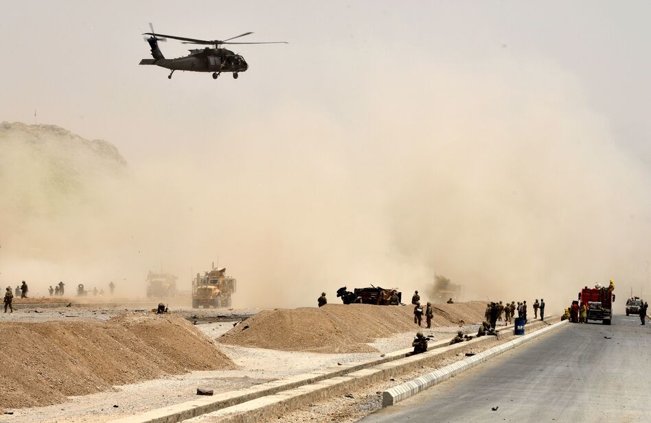 A Black Hawk helicopter flies over the site of a Taliban suicide attack in Kandahar, Afghanistan, on Aug. 2. (Javed Tanveer/AFP/Getty Images)