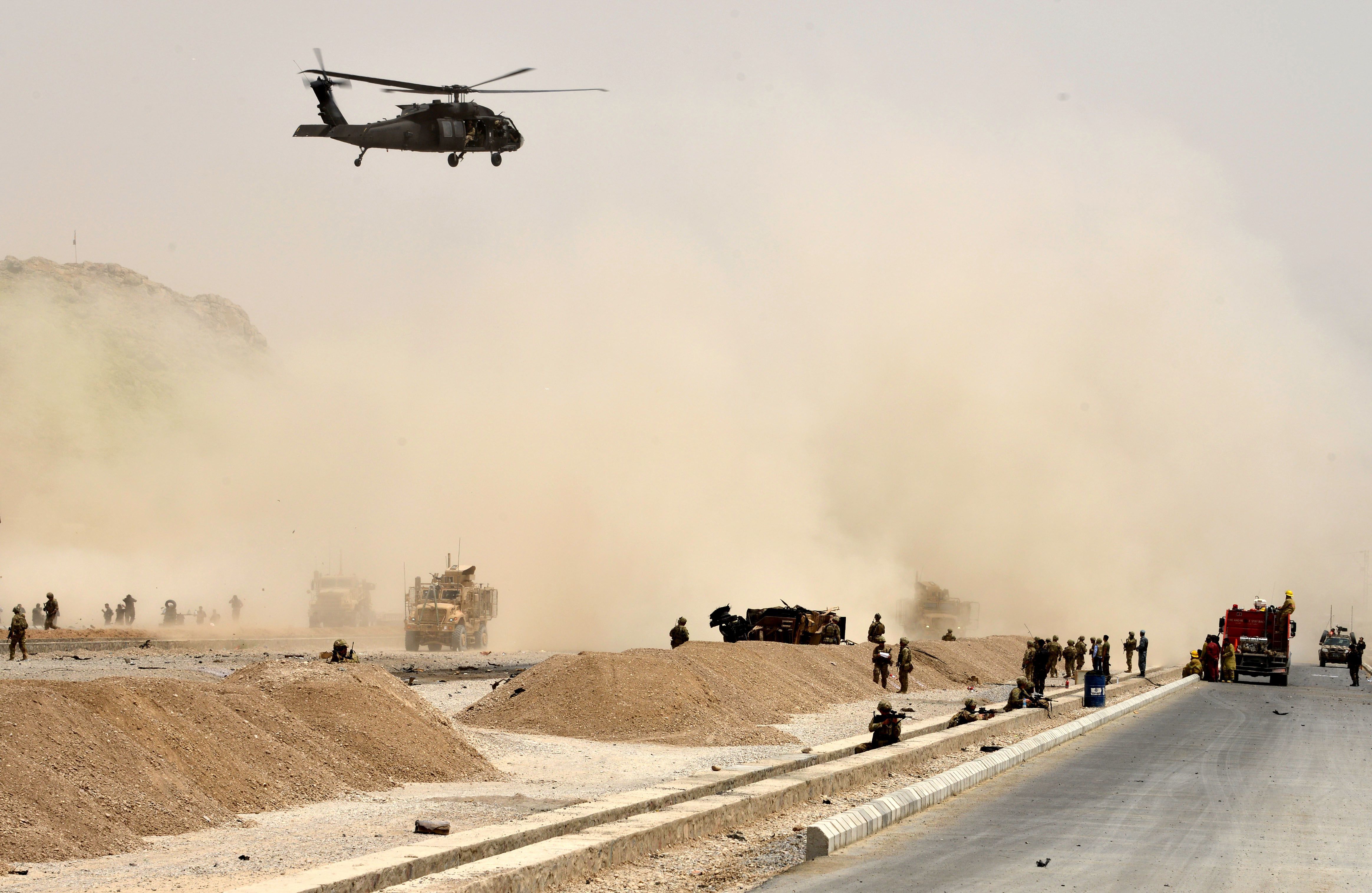 A Black Hawk helicopter flies over the site of a Taliban suicide attack in Kandahar, Afghanistan, on Aug. 2. (AFP/Getty Images)