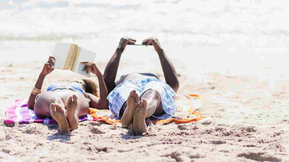 Couple relaxing together on beach.