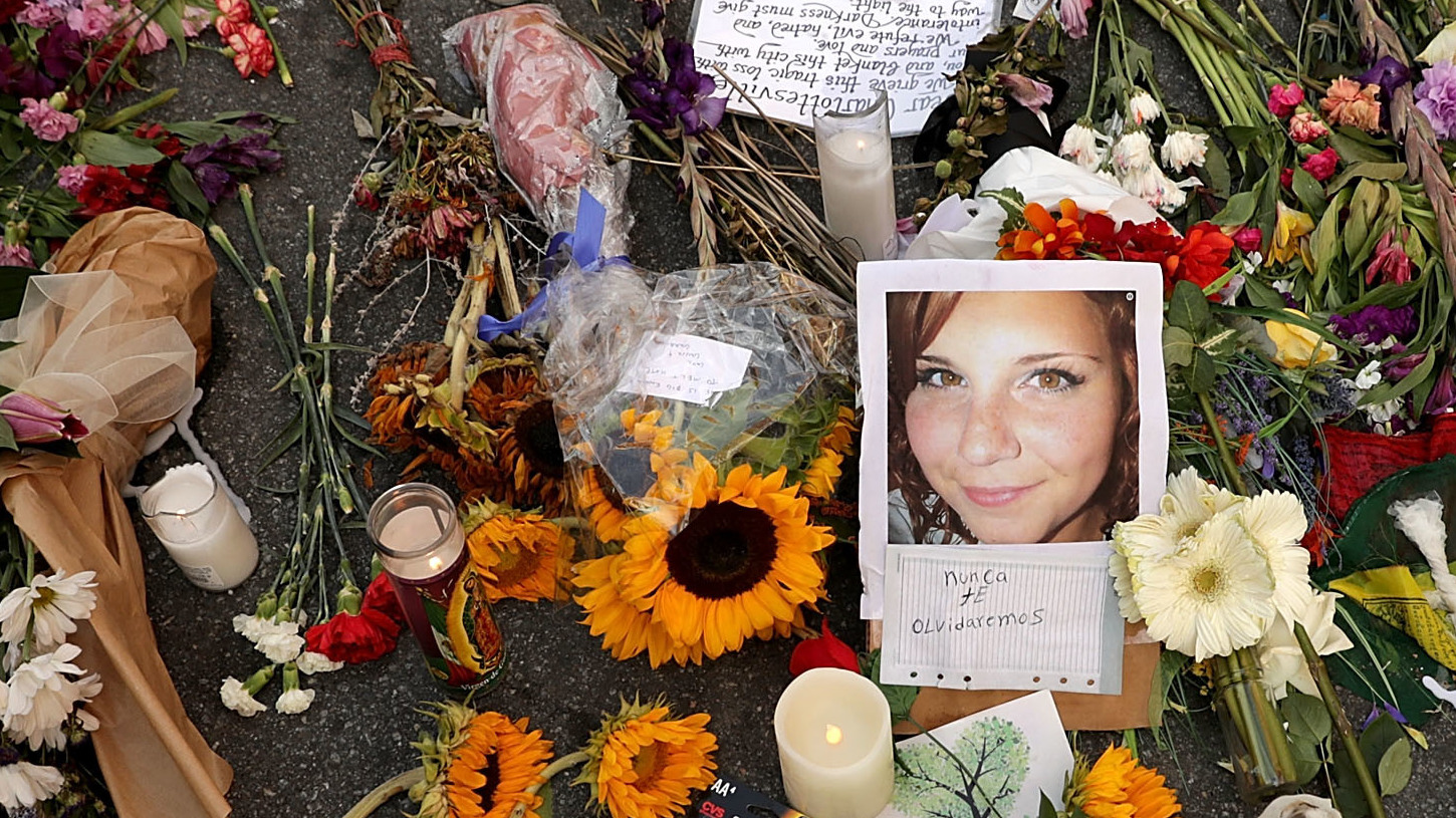 Flowers, candles and chalk-written messages surround a photograph of Heather Heyer on Wednesday, on the spot in Charlottesville, Va., where she was killed and 19 others injured by a car attack on Saturday. (Getty Images)