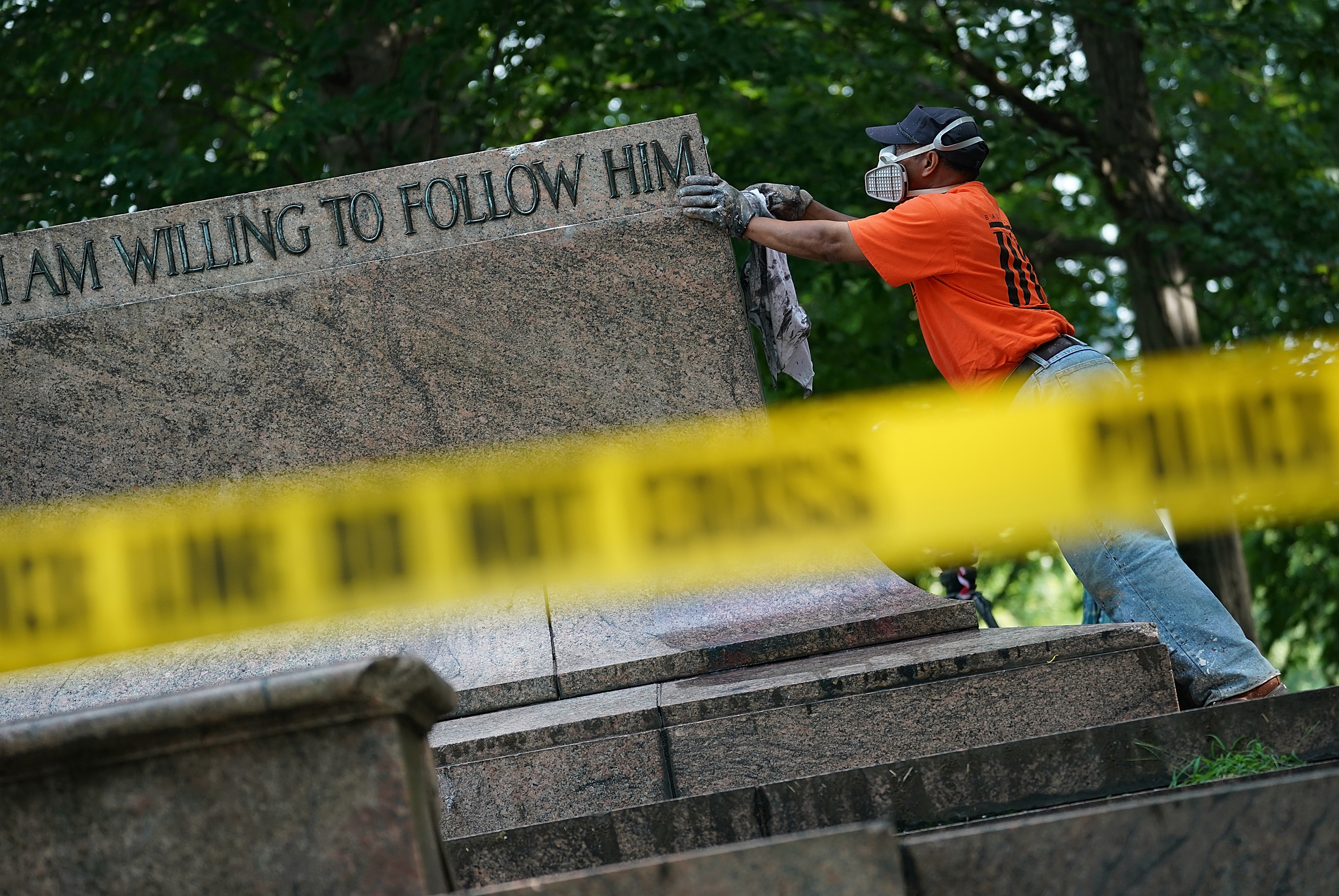 Baltimore city workers remove graffiti from the pedestal where a statue dedicated to Robert E. Lee and Thomas &quot;Stonewall&quot; Jackson stood on Wednesday. The City of Baltimore removed four statues celebrating confederate heroes from city parks overnight, following the weekend's violence in Charlottesville, Va. (Getty Images)