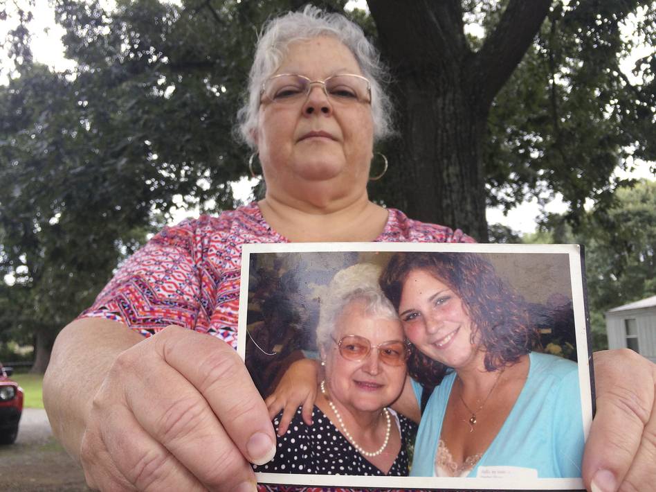 Susan Bro, the mother of Charlottesville victim Heather Heyer, holds a photo of Bro's mother and her daughter on Monday. (Joshua Replogle/AP)