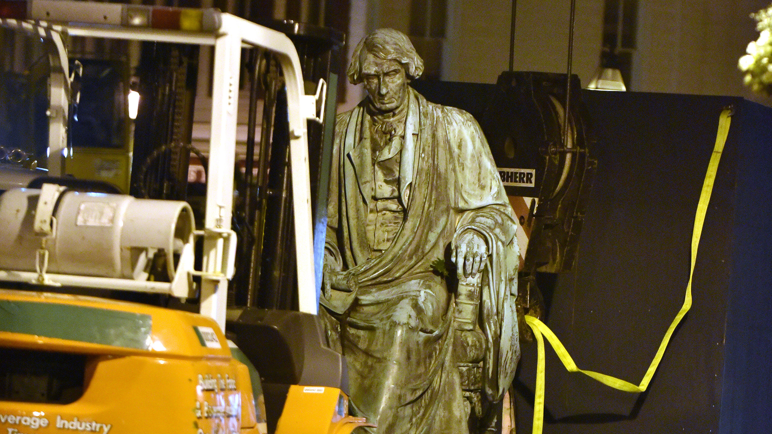 Crews worked to remove the statue of Supreme Court judge and segregationist Roger Taney from the front lawn of the Maryland State House late Thursday night. Taney wrote the 1857 <em>Dred Scott</em> decision that defended slavery and said black Americans could never be citizens. (TNS via Getty Images)