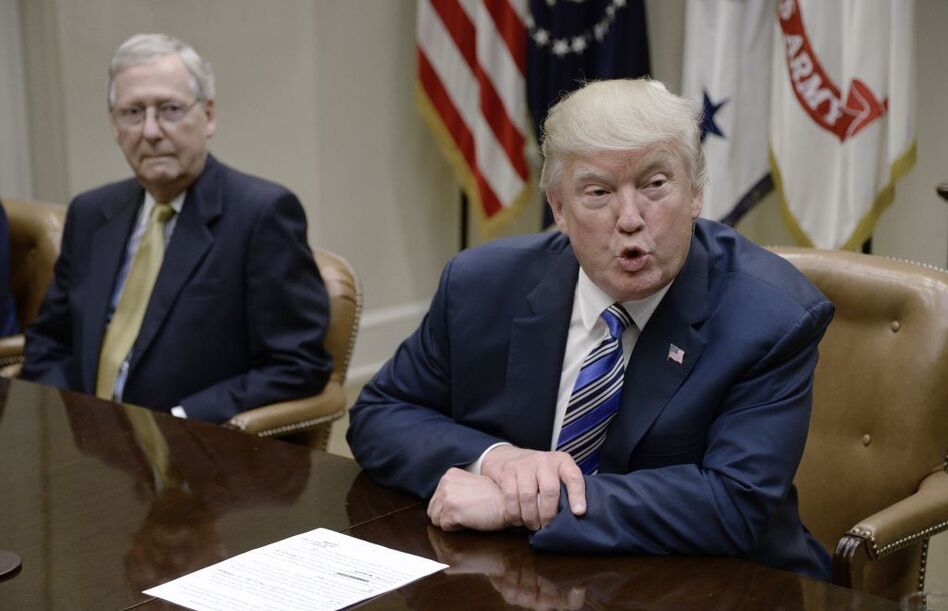 President Trump speaks as Senate Majority Leader Mitch McConnell, R-Ky., looks on during a meeting with House and Senate leadership at the White House in June. (Olivier Douliery/Pool/Getty Images)