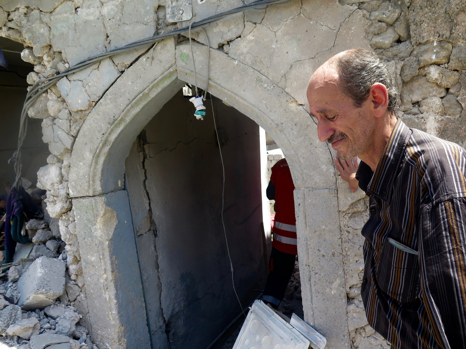 Bashar Abdul Jabar lost his 15-year-old son, Ahmed, when part of their house collapsed during fighting between Iraqi troops and ISIS. He returned to the city to retrieve his boy's body with the help of civil defense forces. (Jane Arraf/NPR)