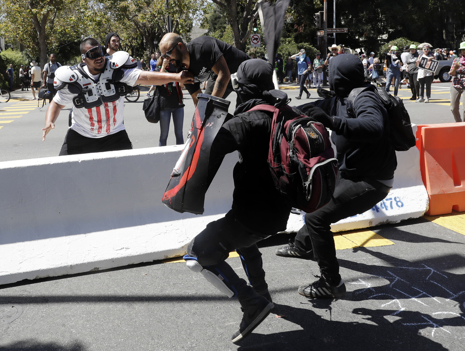 Patriot Prayer founder Joey Gibson (second from left) is chased by anti-fascists during a Rally Against Hate on Sunday in Berkeley, Calif. (Marcio Jose Sanchez/AP)