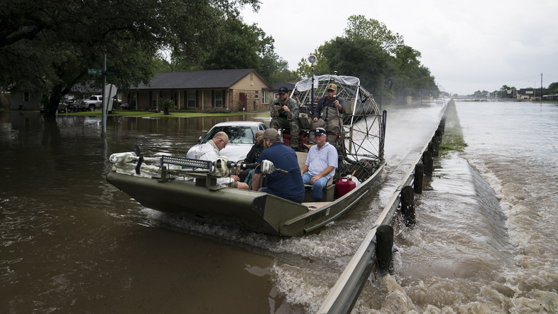 Residents and emergency workers in Houston are struggling to cope with intense flooding and rains brought by Hurricane Harvey. Volunteers use an airboat to rescue people from their flooded homes along Beamer Road in Houston on Sunday. (Jabin Botsford/The Washington Post/Getty Images)