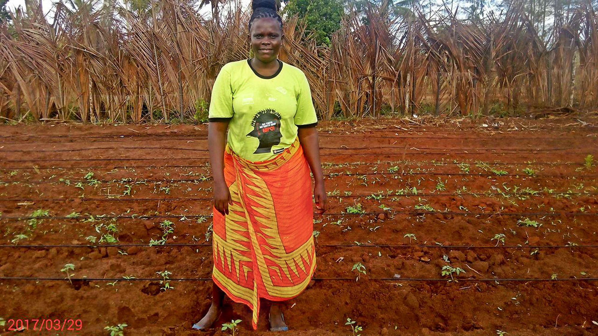 Faith with her beloved tomato seedlings. (Courtesy of the family)