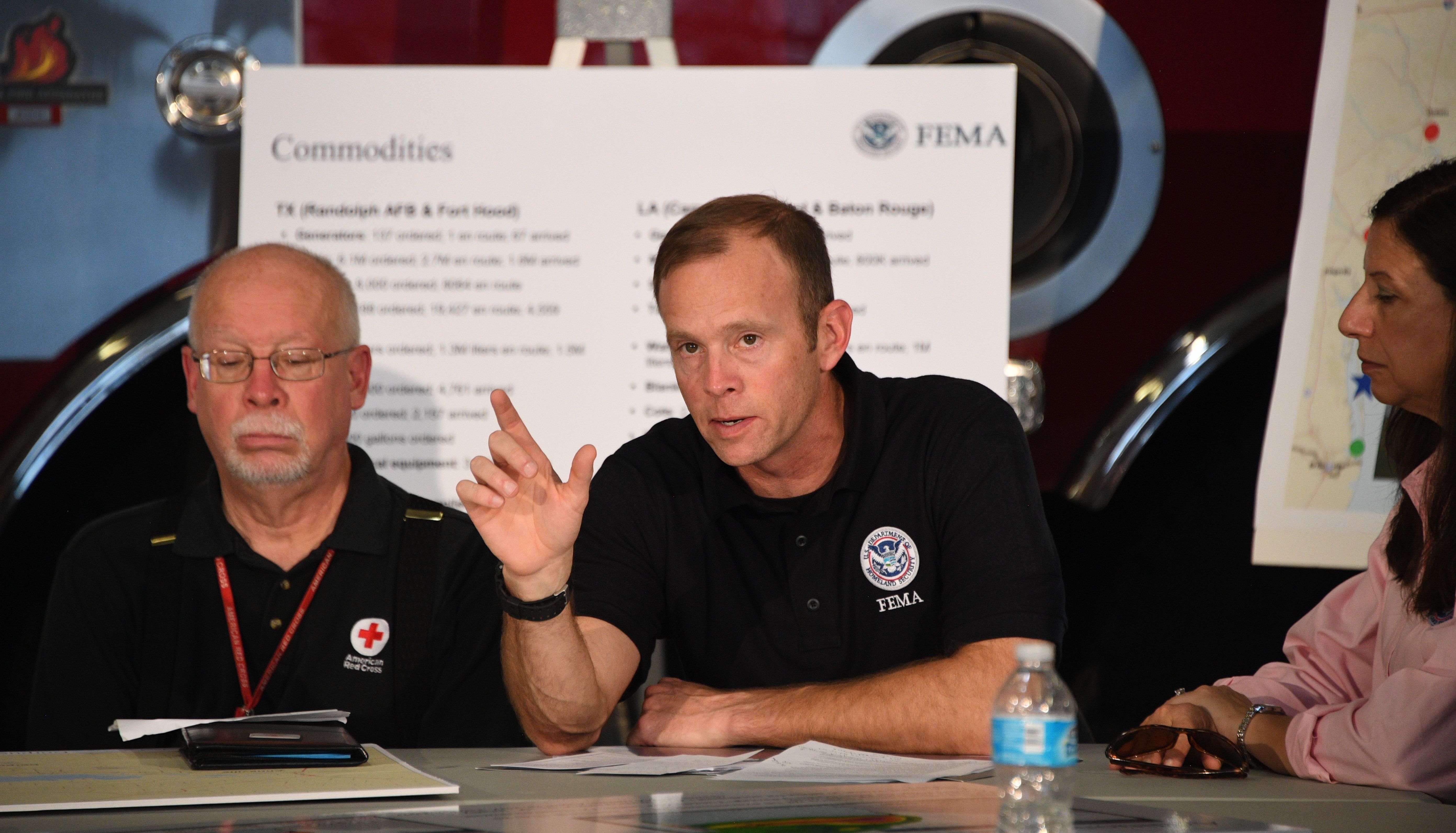 Administrator Brock Long of FEMA (center) speaks during a firehouse briefing on Hurricane Harvey in Corpus Christi, Texas, on Tuesday.