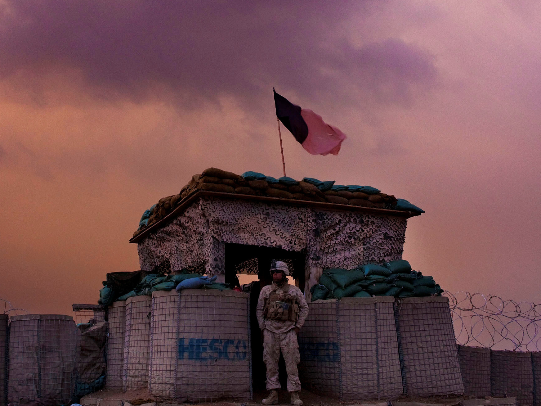 A U.S. Marine looks out as an evening storm gathers above an outpost near Kunjak, in southern Afghanistan's Helmand province. (Reuters/Viking)