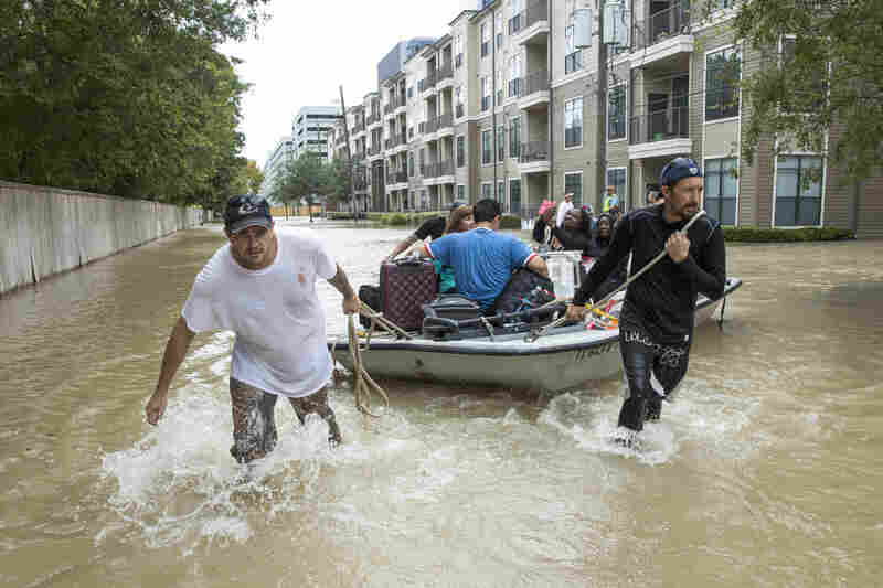Residents are evacuated from an apartment complex near the Energy Corridor of west Houston on Wednesday. The confirmed death toll from Harvey is at least 10, across four Texas counties.