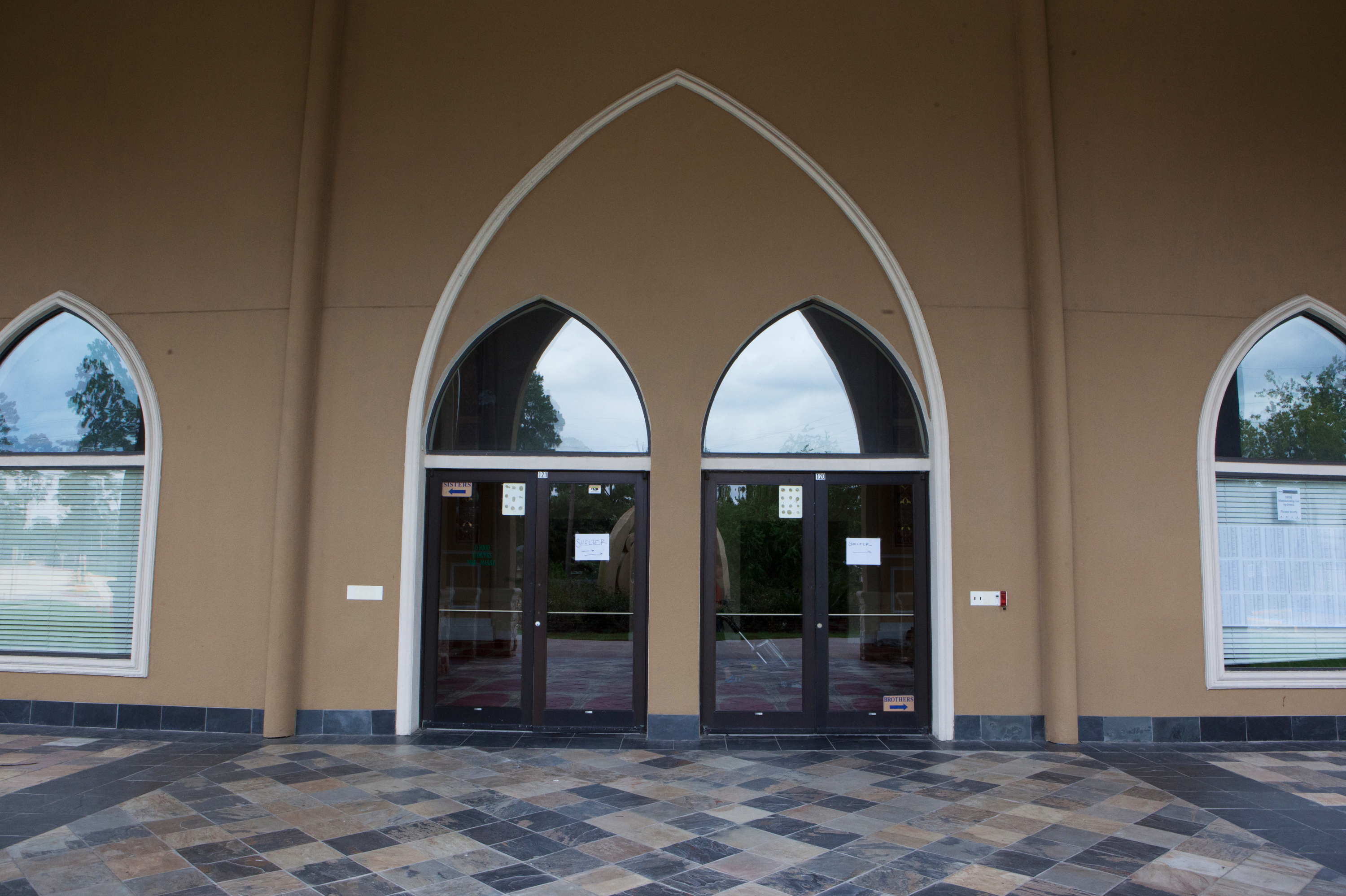 Al-Salam mosque in Houston opened its doors and offered shelter during Hurricane Harvey. The doors have paper signs taped to them directing people to the shelter area. (NPR)