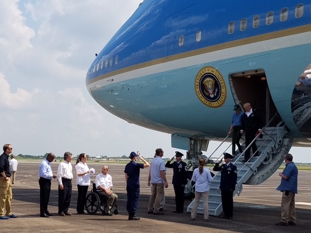 The president and first lady are greeted by Texas Gov. Greg Abbott, among others, upon their arrival in Houston Saturday.