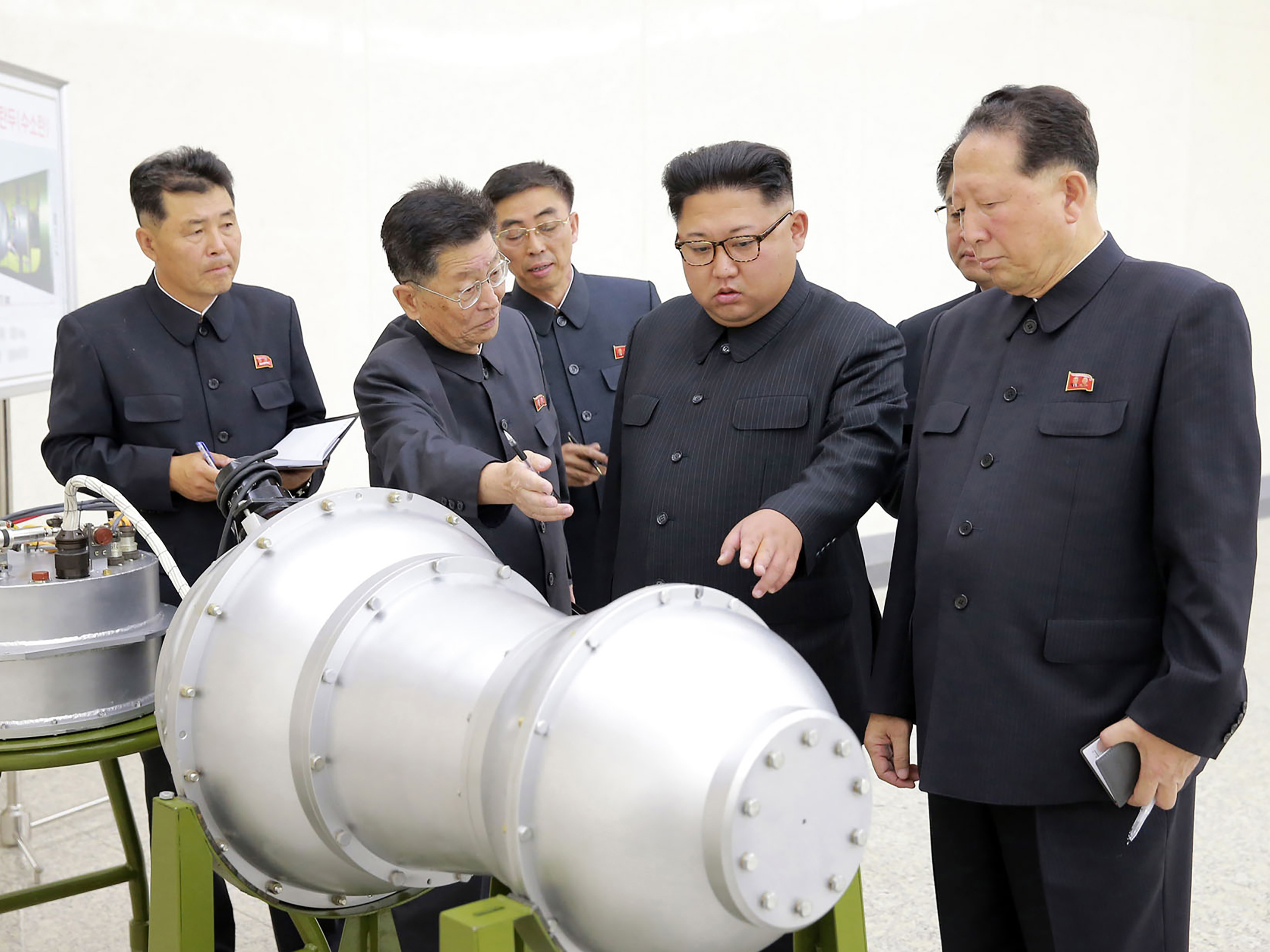This undated picture released by North Korea's state-run news agency Sunday shows North Korean leader Kim Jong Un looking at what Pyongyang claims is a hydrogen bomb.