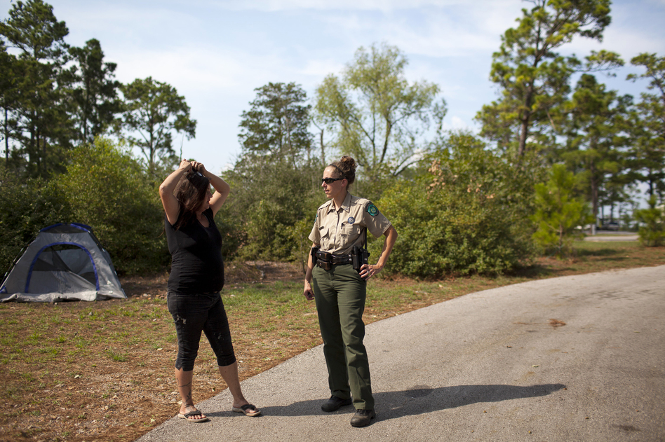 Susan Arawley (left) speaks with Jamie Creacy, superintendent of the Lost Pines Complex, which includes Bastrop State Park. As Hurricane Harvey hit, Arawley tried picking up supplies and got stuck in rising flood water. After sleeping in her car four nights, she decided to head to Bastrop State Park, where she could take a shower. (Katie Hayes Luke for NPR)