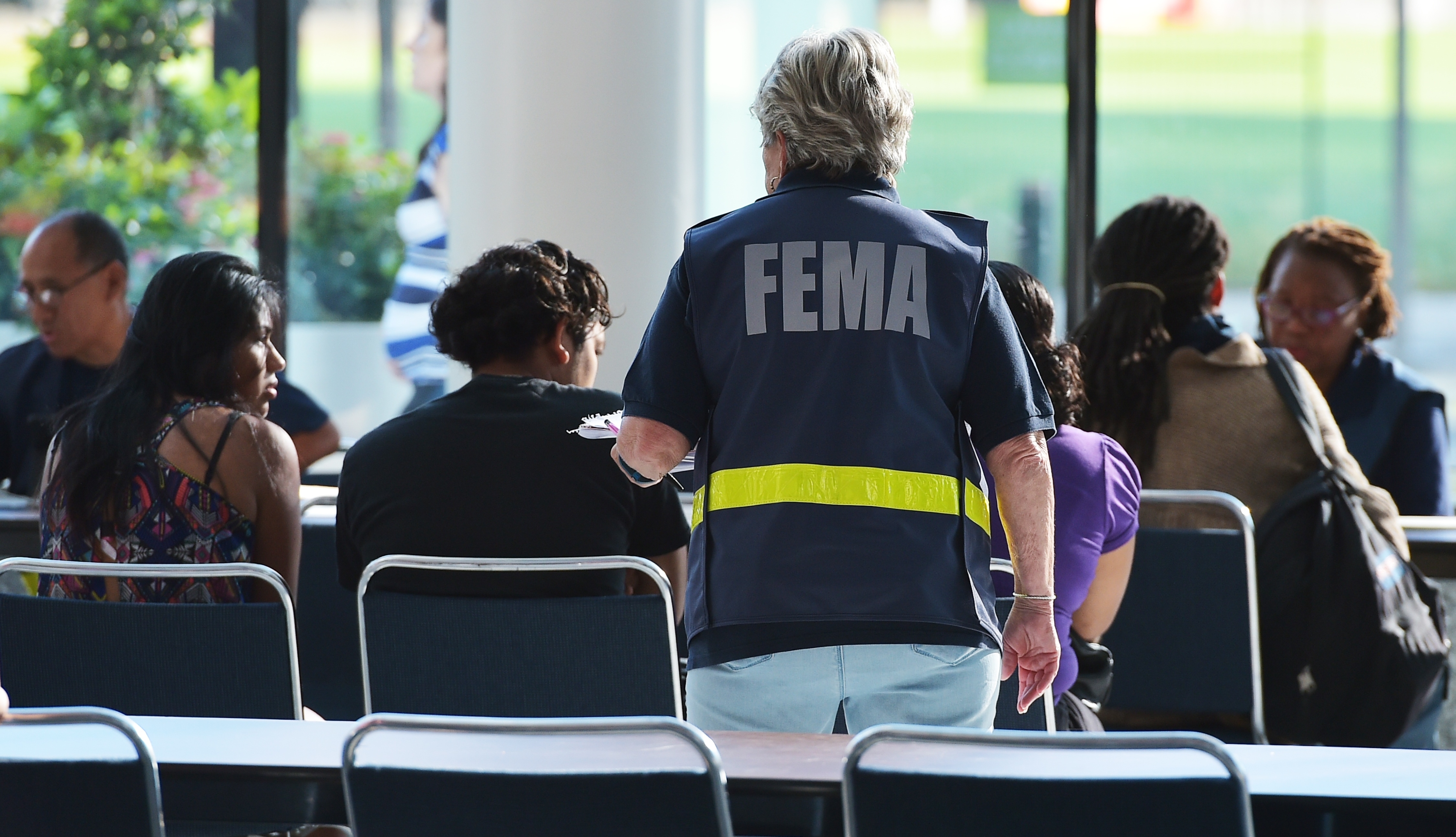 An official with the Federal Emergency Management Agency talks to people at Houston's George R. Brown Convention Center, which has been a shelter for evacuees from Hurricane Harvey, on Sept. 2. (AFP/Getty Images)