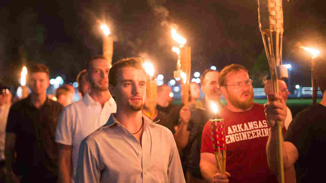 White supremacists march with tiki torchs through the University of Virginia campus. (Photo by Zach D Roberts/NurPhoto via Getty Images)
