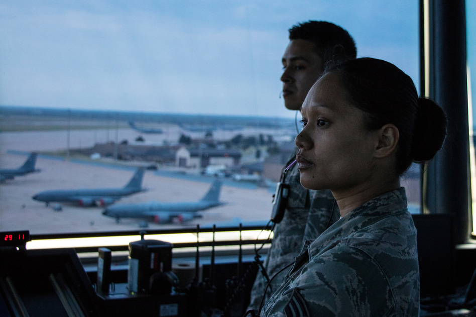 Senior Airman Yazmine Nanasca with a control tower crew at Altus Air Force Base guide a C-17 cargo plane a KC-135 tanker as it taxis to the runway for a day-long training mission in southwestern Oklahoma. (Joe Wertz/StateImpact Oklahoma)