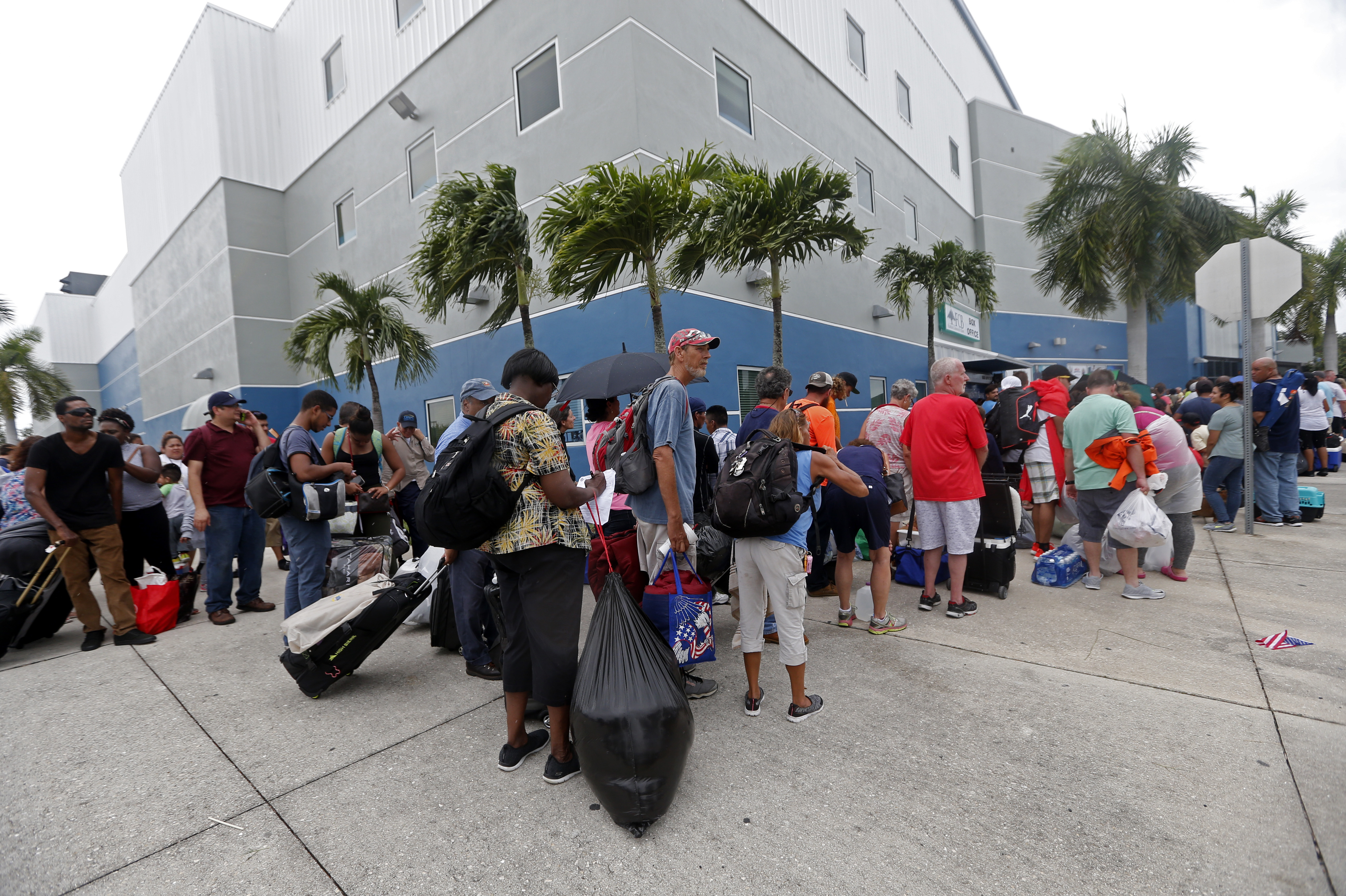 Evacuees stand in line to enter the Germain Arena, which is being used as a fallout shelter, in advance of Hurricane Irma, in Estero, Fla., Saturday.