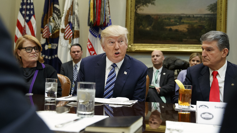 President Donald Trump, flanked by Sen. Heidi Heitkamp, D-N.D., (left) and Sen. Joe Manchin, D-W.Va., speaks during a meeting with senators on his Supreme Court Justice nominee Neil Gorsuch, on Feb. 9, 2017, in the Roosevelt Room of the White House. (Evan Vucci/AP)