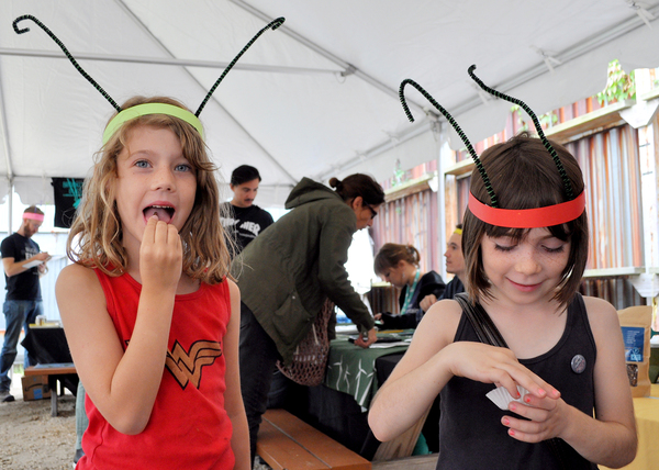 Tennesee Nydegger-Sandidge (left) and Holly Hook try chowing down on some crickets. "People should eat them because they're good for the planet," says Tennessee.