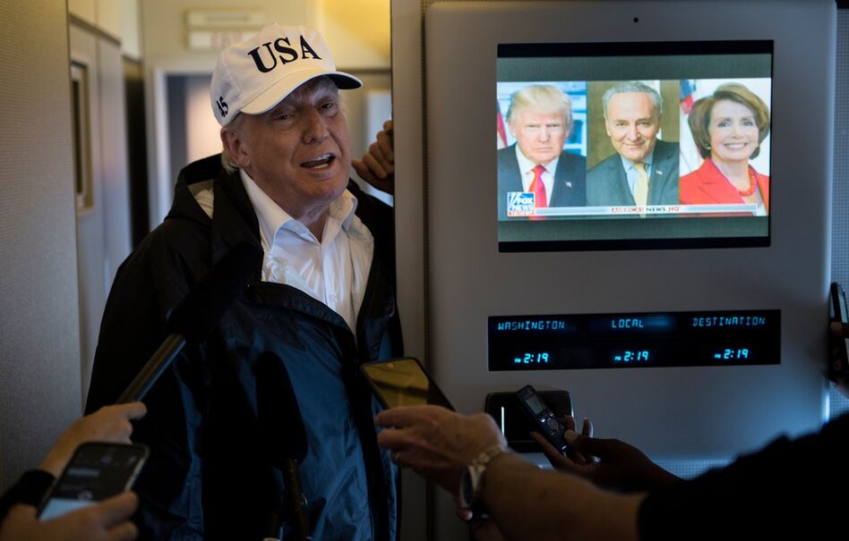 President Trump speaks to the press onboard Air Force One while flying back to Andrews Air Force Base from Florida on Thursday. (Brendan Smialowski/AFP/Getty Images)
